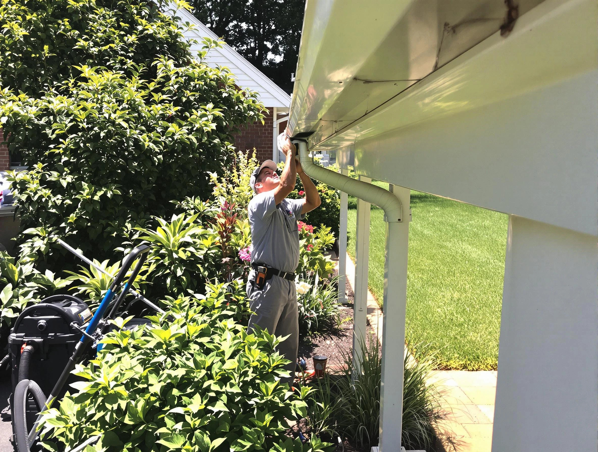 Technician flushing a blockage from a downspout in Mayfield Heights, OH